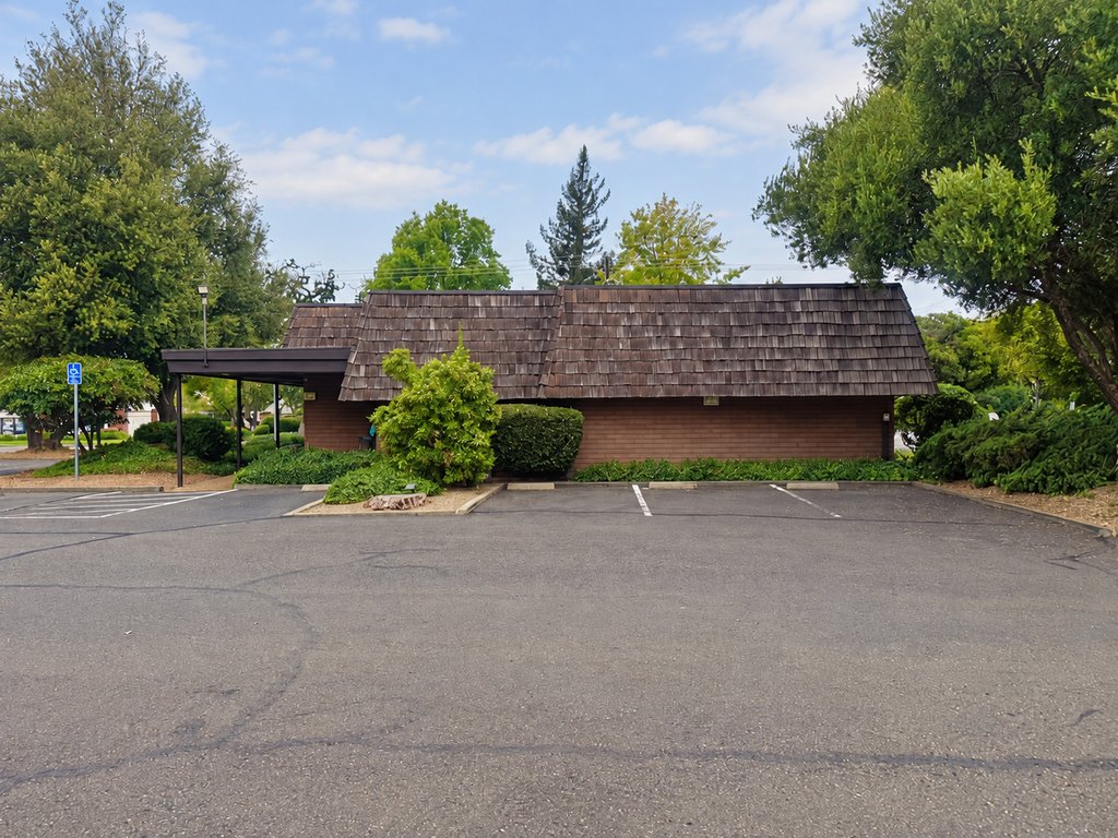 On-site parking in front of the low-rise medical office building on a bright summer day