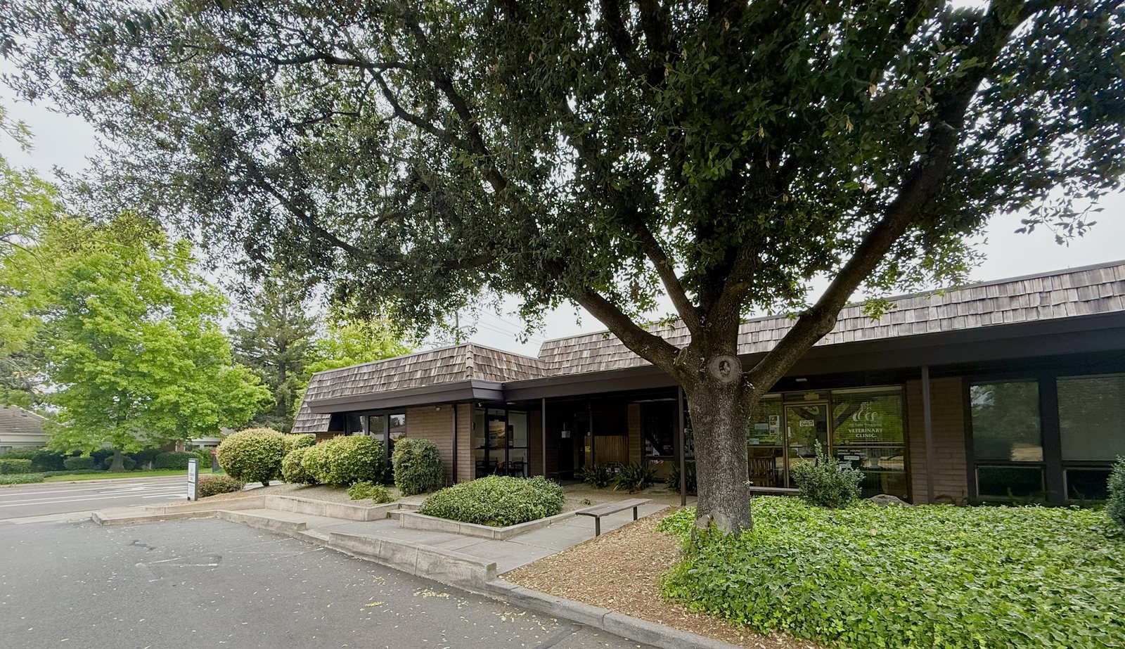 Low-rise medical office building housing Dr. Korves’s Suite B practice beneath mature trees